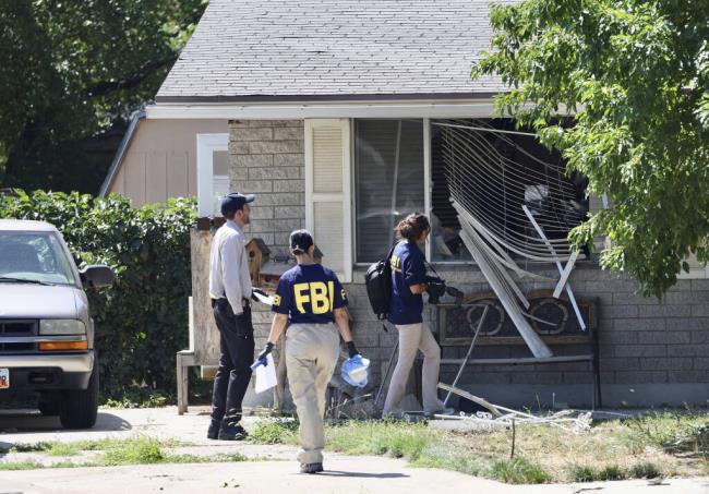 FILE - Law enforcement investigate the scene of a shooting involving the FBI on Aug. 9, 2023, in Provo, Utah. The Utah man accused of making violent threats against President Joe Biden before a western states trip last week pointed a handgun at FBI agents attempting to arrest him, the agency said on Monday, Aug. 14, 2023. (Laura Seitz/The Deseret News via AP, File)