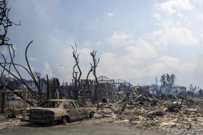 Wildfire wreckage is seen Wednesday, Aug. 9, 2023, in Lahaina, Hawaii. The scene at one of Maui's tourist hubs on Thursday looked like a wasteland, with homes and entire blocks reduced to ashes as firefighters as firefighters battled the deadliest blaze in the U.S. in recent years. (Tiffany Kidder Winn via AP)