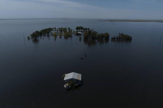 FILE - Farmland in the Tulare Lake Basin is submerged in water in Corcoran, Calif., April 20, 2023, after more than a dozen atmospheric rivers dumped record-setting rain and snowfall. (AP Photo/Jae C. Hong, File)