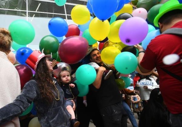 Visitors enjoy the balloon drop during the Noon Year’s Eve...