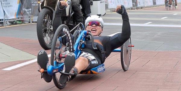 A jubilant Lim crossing the finishing line at a road race in Putrajaya during the 2017 SEA Games.