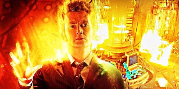 David Tennant holds out his hand, surrounded by golden light and flames
