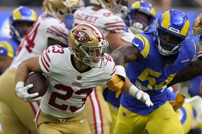 49ers running back Christian McCaffrey avoids a tackle against the Los Angeles Rams during their Oct. 30 game last season. (Ashley Landis / ASSOCIATED PRESS)