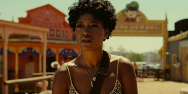 Keke Palmer looking puzzled at a Wild West theme park in Nope