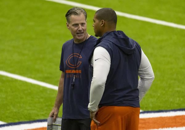 Bears coach Matt Eberflus, left, and general manager Ryan Poles talk during training camp on July 26, 2023, in the Walter Payton Center at Halas Hall.