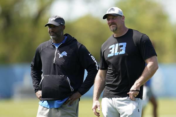 Lions general manager Brad Holmes, left, and coach Dan Campbell speak during a practice on May 14, 2022, in Allen Park, Mich.