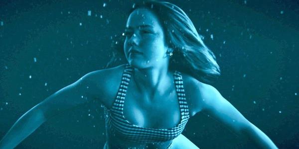 Girl swimming under water in a bathing suit in Night Swim