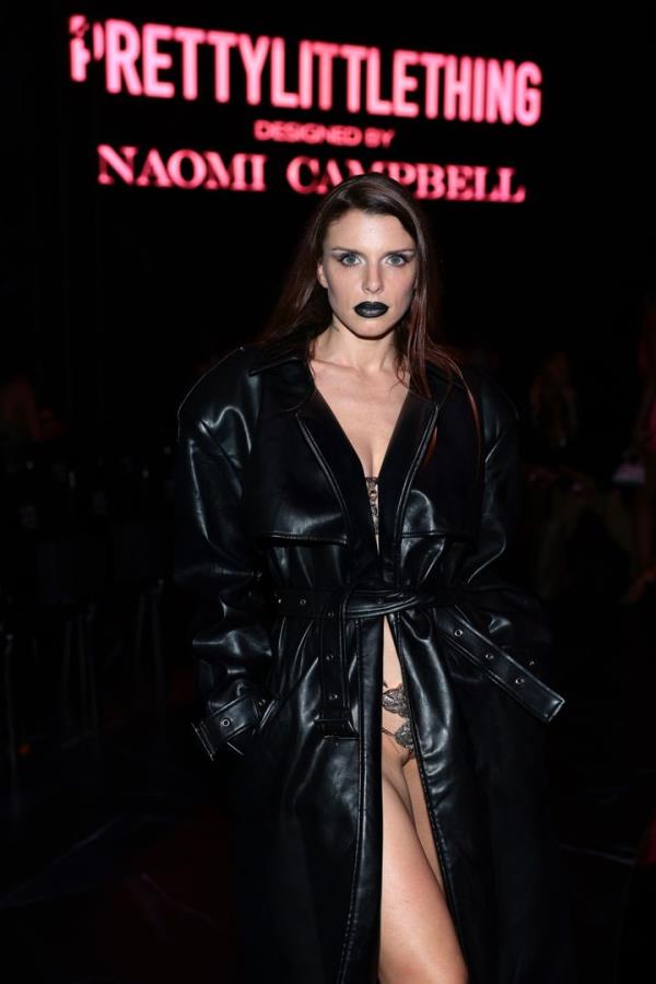 Julia Fox attended the PrettyLittleThing x Naomi Campbell runway show in a floor-length black trenchcoat.